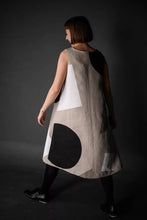 Load image into Gallery viewer, Back view of model in motion, wearing sleeveless version of Trapeze dress shows off flare