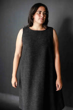 Load image into Gallery viewer, Model wears sleeveless version of Trapeze dress, in a woollen fabric