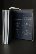 Load image into Gallery viewer, Merchant & Mills Workwear Book displayed open to show pack of sewing patterns at the rear.