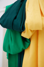 Load image into Gallery viewer, Three colours of EcoVero Viscose Leia Crepe Fabric hangs together over a rod