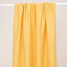 Load image into Gallery viewer, EcoVero Viscose Leia Crepe Fabric hangs over a rod