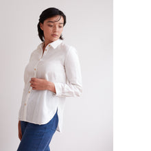 Load image into Gallery viewer, Model wears a collared button-up shirt with curved hem