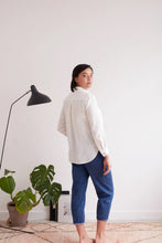 Load image into Gallery viewer, Back view of model wearing a collared shirt, with inverted pleat at centre of yoke