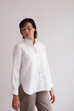 Load image into Gallery viewer, Model wears a collared button-up shirt with curved hem