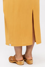 Load image into Gallery viewer, Close up view of centre-back slit from hem of skirt