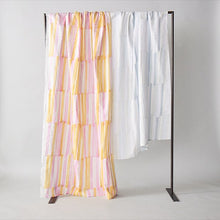 Load image into Gallery viewer, Organic cotton double gauze fabric sheets hang over a rail, of bold pen strokes design in two different colours
