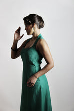 Load image into Gallery viewer, Side view of lady wearing a sleeveless, seamed, sweetheart neckline dress with a-line skirt