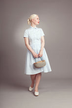 Load image into Gallery viewer, Lady wears a short sleeve button up shirt with rounded collar, with waist to bust darts with matching flared gored skirt