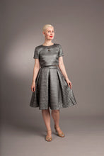 Load image into Gallery viewer, Lady wears a fitted cropped blouse with pleated gored skirt