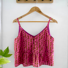 Load image into Gallery viewer, Strappy vest top with button front and peplum displayed on hanger. made with Nevermind Modal fabric