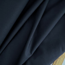 Load image into Gallery viewer, Organic Cotton Fabric displayed in soft folds next to a wooden ruler