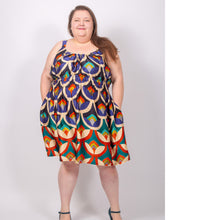 Load image into Gallery viewer, Model wears a sleeveless, knee-length dress, with rounded neckline, elasticated waistline, hands in side pockets