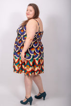 Load image into Gallery viewer, Side view of model wearing a sleeveless, knee-length dress, elasticated back and waistline