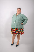 Load image into Gallery viewer, Model wears a loose-fitting jacket with sunburst tucks around the neckline, and patch pockets, worn fastened with four buttons