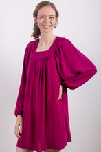 Load image into Gallery viewer, Model wears a loose-fitting dress gathered to a square neckline, with long voluminous sleeves.