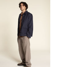 Load image into Gallery viewer, Man stands with hands in trouser pockets, wearing a loose box fit jacket