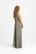 Load image into Gallery viewer, Side view of lady wearing full length dress with low scoop back and inset side pockets at hip level