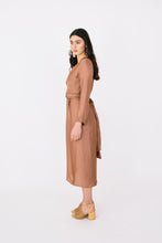 Load image into Gallery viewer, Side view of lady wearing midi length dress with ties at back hanging from waist level, long sleeve.