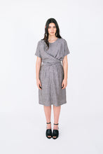 Load image into Gallery viewer, Lady wears a knee length dress with a short sleeve wrap across top