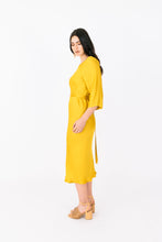 Load image into Gallery viewer, Side view of lady wearing Ravine Dress with 3/4 length sleeves and blas cut skirt mid-calf length