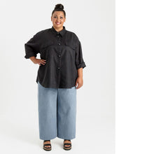 Load image into Gallery viewer, Lady wears a long sleeved, rolled up, button up shirt with patch pockets at chest