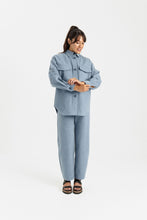 Load image into Gallery viewer, Lady wears a long sleeved, button up shirt with patch pockets at chest