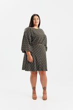 Load image into Gallery viewer, Lady wears a long puff sleeve dress with bias cut skirt, knee length