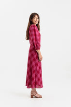 Load image into Gallery viewer, Side view of lady wearing a long puff sleeve dress with bias cut skirt, midi length