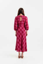 Load image into Gallery viewer, Back view of lady wearing a long puff sleeve dress with keyhole back detail, with bias cut skirt, midi length