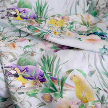 Load image into Gallery viewer, Viscose fabric with print of parrots florals, displayed with soft folds
