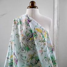 Load image into Gallery viewer, Viscose fabric with print of parrots florals, displayed draped on mannequin