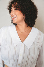 Load image into Gallery viewer, Collar detail of lady wearing a V-neck collared, button-up blouse