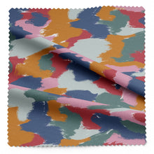 Load image into Gallery viewer, Vibrations EcoVero Viscose Fabric shown with soft folds in drape, with a multicoloured brush patches print