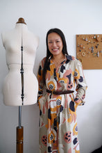 Load image into Gallery viewer, Lady stands next to mannequin wearing a maxi button-up shirtdress, made in the Abstract Ecovero Viscose fabric