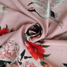 Load image into Gallery viewer, Viscose Fabric with oversized blooms amongst storks mid-flight pattern, displayed with central swirl