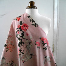 Load image into Gallery viewer, Viscose Fabric with print of oversized blooms amongst storks in flight, displayed draped on mannequin