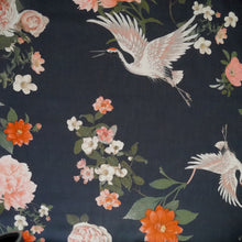 Load image into Gallery viewer, Cotton fabric with oversized blooms, and storks in mid-flight pattern, displayed flat