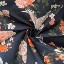 Load image into Gallery viewer, Cotton fabric with oversized blooms, and storks in mid-flight pattern, displayed with central swirl