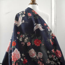 Load image into Gallery viewer, Cotton fabric with oversized blooms, and storks in mid-flight pattern, draped on mannequin