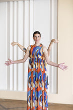 Load image into Gallery viewer, Lady wears a sleeveless vest top and maxi skirt dress in patterned fabric
