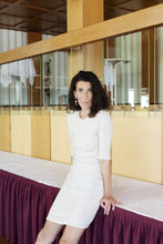 Load image into Gallery viewer, Lady wears a figure hugging elbow sleeve, above knee length dress