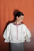 Load image into Gallery viewer, Lady wears a puffy sleeve blouse adorned with a patterned fabric peter pan collar, tied at centre neckline with long ribbon