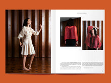 Load image into Gallery viewer, Double page magazine spread features images of ladies wearing either a dress or blouse with gathered round neckline, button front, in sheer and draping fabrics