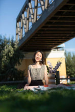 Load image into Gallery viewer, Lady sits on a picnic blanket under a bridge, wearing a square neckline, sleeveless, shaped bodice top