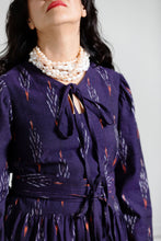 Load image into Gallery viewer, Close up of chest detail of model wearing a dress with bodice fastened with ties at centre-front round neckline