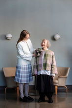 Load image into Gallery viewer, Two models wearing open jackets, one model assisting with an oversized fabric rose brooch