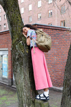 Load image into Gallery viewer, Lady leans against a tree wearing wide legged trousers and backpack.