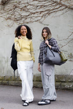Load image into Gallery viewer, Two ladies carrying bags wearing cargo style trousers.
