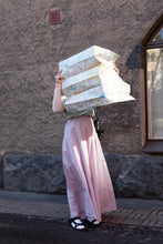 Load image into Gallery viewer, Lady wears a long tiered skirt holding a map