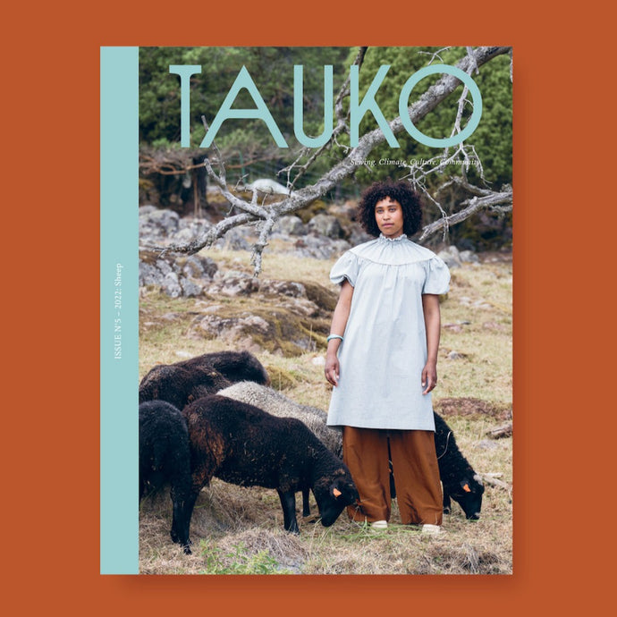 TAUKO magazine cover issue no 5 features a lady stood amongst sheep wearing a short sleeve A-line dress with gathered yoke detail